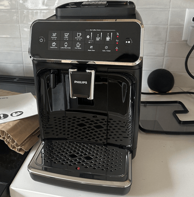 Philips 2200 LatteGo super automatic espresso machine with LatteGo milk carafe on a kitchen counter.