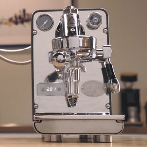 ECM Puristika espresso-only E61 machine with PID, front pressure gauge, and external glass reservoir.