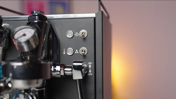 Close-up of La Pavoni Mini Cellini control panel with switches and indicator lights.